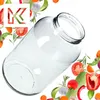 A clear glass jar is shown at an angle, surrounded by various fresh vegetables and herbs. Podgląd zdjęcia produktu
