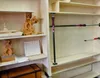 Shelves in a workshop with wooden carvings and tools. Anteprima dell’immagine prodotto