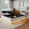 A bed with its storage compartment open, revealing stored items and illuminated by LED lights. Náhľad obrázku produktu