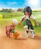 A person is feeding a baby goat and a goat on a farm. Produktbild-Vorschau