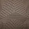 A close-up view of a brown quilted blanket with a geometric triangle pattern. Produktbild-Vorschau