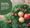A close-up of a Christmas garland decorated with red and gold baubles, set against a wooden background. Anteprima dell’immagine prodotto