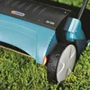 Close-up of a lawn aerator on grass. Produktbild-Vorschau