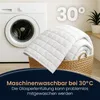 A weighted blanket is shown in a laundry basket next to a washing machine, with a temperature indicator of 30°C. Produktbild-Vorschau