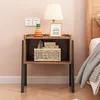 A bedside table with a lamp, a framed picture, a toy, and a basket of items. Podgląd zdjęcia produktu