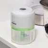 A white and green mini food chopper sits on a white shelf. Náhľad obrázku produktu