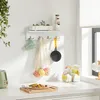 A kitchen counter with a shelf above it, displaying various kitchen items and food. Produktbild-Vorschau