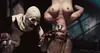 A terrifying clown character stands next to a person hanging upside down. Produktbild-Vorschau
