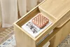 A close-up shot of a wooden storage unit with a book, glasses, and a small wooden box with a chessboard pattern on top. Podgląd zdjęcia produktu