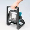 A hand holding a portable LED work light. Podgląd zdjęcia produktu