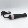 A black and rose gold hair dryer with a cord is lying on a white surface. Anteprima dell’immagine prodotto