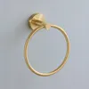 A gold-colored towel ring mounted on a light gray wall. Podgląd zdjęcia produktu