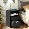 A bedside table with drawers next to a bed. Náhled obrázku produktu