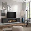 A modern living room with a wall-mounted TV cabinet featuring an electric fireplace, artwork on the wall, and a window with curtains. Produktbild-Vorschau