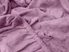 A close-up view of a pink terry cloth bedsheet, showing the texture and elasticized edge. Náhľad obrázku produktu