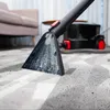 A carpet cleaning machine is being used to clean a carpet in a living room. Náhled obrázku produktu