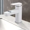 A white modern faucet with a digital display showing the temperature, placed on a marble countertop next to a sink. Produktbild-Vorschau