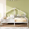 A white wooden house-shaped bed for children, decorated with string lights and a fox-shaped pillow. Produktbild-Vorschau