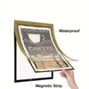 A hand is shown holding a magnetic photo frame with a coffee shop design, highlighting its features. Náhled obrázku produktu