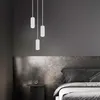 A bedroom scene with a bed and a nightstand, illuminated by pendant lights. Produktbild-Vorschau