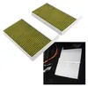 Two cabin air filters are shown in the foreground, with a close-up of two installed filters in the background. Náhled obrázku produktu