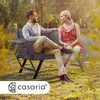 A couple sitting on a garden bench in a sunny outdoor setting. Anteprima dell’immagine prodotto