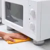 A hand is cleaning under a white microwave that is elevated by anti-vibration feet. Anteprima dell’immagine prodotto