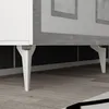 Close-up view of the legs and bottom of a white cabinet with silver accents. Anteprima dell’immagine prodotto