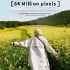 A person walks through a field of yellow flowers with a scenic background. Náhled obrázku produktu