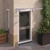 A door canopy is installed above a front door of a brick house. Anteprima dell’immagine prodotto