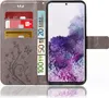 A grey flip phone case with card slots and banknotes is shown open, displaying a smartphone with a floral wallpaper. Produktbild-Vorschau