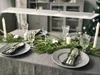 A dining table set for a festive meal with Christmas decorations. Produktbild-Vorschau