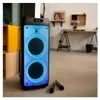 A portable Bluetooth speaker with colorful lighting and two microphones in a room with furniture. Náhľad obrázku produktu