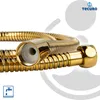 A close-up shot of a gold-colored shower hose with its connectors. The product is shown against a white and light gray background with some abstract graphic elements. Produktbild-Vorschau