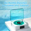 A white retro-style record player with a transparent blue lid and a green record sits on a white surface, with a blue water-like background. Produktbild-Vorschau