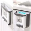 A collage showing a foldable trash can mounted on a cabinet door, with one image showing it open and ready for use, and the other showing it closed. Náhľad obrázku produktu