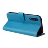 A blue flip phone case with a floral and butterfly design is shown open, displaying the inside of the case and the back of a phone with its camera. Produktbild-Vorschau