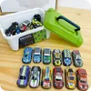 A collection of toy cars displayed on a wooden surface, with a white storage bin and a green carrying case in the background. Náhľad obrázku produktu