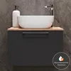 A modern bathroom vanity with a vessel sink and faucet, set against a tiled wall. Produktbild-Vorschau