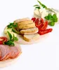 A selection of food items, including bread, cheese, meat, and vegetables, arranged on wooden boards against a white background. Podgląd zdjęcia produktu