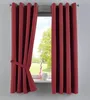 A close-up view of a red curtain tied back with a fabric tie, revealing a window with greenery outside. Produktbild-Vorschau