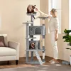 A woman is interacting with a cat on a tall cat tree in a living room. Produktbild-Vorschau