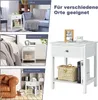 Collage of images showing a white nightstand in different room settings (living room, bedroom, study) and a separate image of the nightstand. Anteprima dell’immagine prodotto