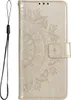 A gold flip phone case with a mandala pattern embossed on it, shown flat against a white background. A black lanyard is attached to the left side of the case. Produktbild-Vorschau