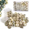 A collection of gold and silver Christmas ornaments, some in packaging and some scattered. Anteprima dell’immagine prodotto