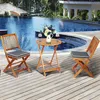 A wooden bistro set with two chairs and a table is placed on a wooden deck next to a swimming pool. Náhľad obrázku produktu