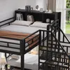 A bunk bed with a built-in bookshelf and stairs, shown in a bedroom setting with a window in the background. Voir les images du produit