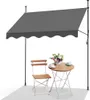 An outdoor awning set up over a small table and chair.