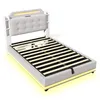 A bed frame with a headboard and mattress support slats, illuminated by LED lights. Produktbild-Vorschau