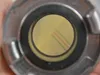 A close-up view of the end of a fire hose, showing the internal mesh and colored threads. Voir les images du produit